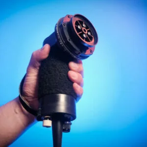 a physiotherapist holds the vibracussor percussor device a Chiropractic Tool For Massage, Fascia and soft tissue